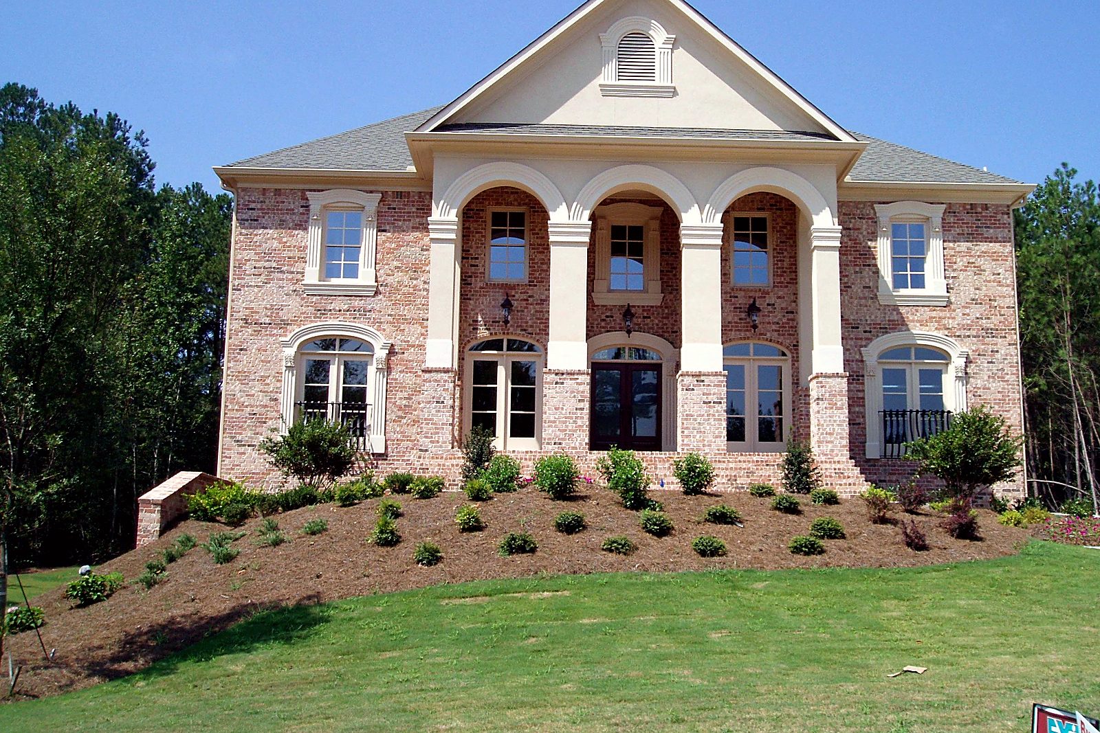 Brick Home with Arched Two-Story Porch